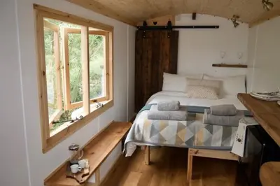 a bedroom with a bed and a window at Little Dolwen - Sioned in Llanwenog