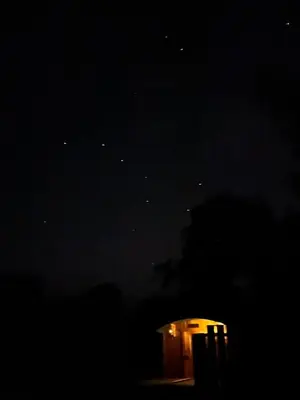 a night sky with a lit up object in the dark at Little Dolwen - Sioned in Llanwenog