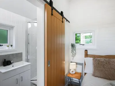 a bedroom with a bed and a sink and a mirror at Mini Lodge - Uk47682 in Montgomery