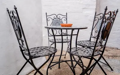 two chairs and a table with a bowl on it at Cottage in Ludlow in Ludlow
