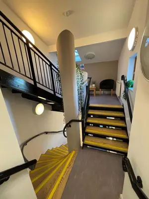 a staircase in a house with yellow and black stairs at Llety Glyndwr - Bunkhouse in Trawsfynydd