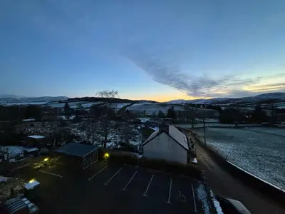 a view of the sunset from the roof of a house at Llety Glyndwr - Bunkhouse in Trawsfynydd