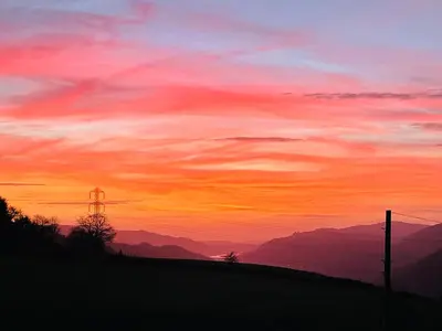 a sunset on a hill with a mountain at Penrallt Bach in Blaenau-Ffestiniog