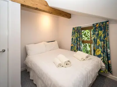 a bedroom with a bed with towels on it at 2 bedroom home within walking distance of the town - Pass the Keys in Shrewsbury