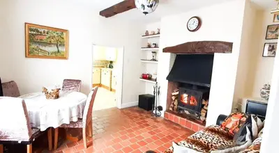 a living room with a table and a fireplace at St Julians house in Shrewsbury
