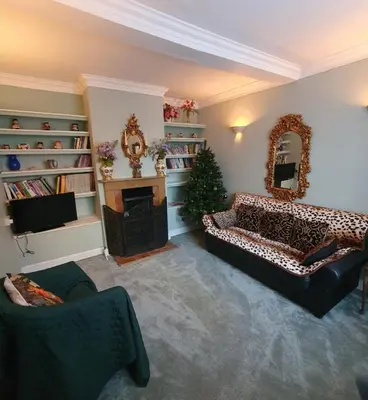 a living room with a christmas tree and a couch at St Julians house in Shrewsbury
