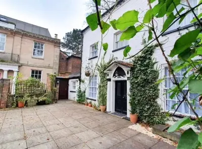 a large white house with a driveway in front of it at St Julians house in Shrewsbury