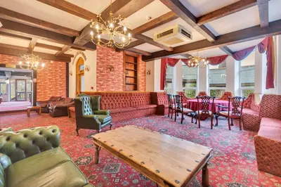 a living room with couches and a table at White Waters Bed and Breakfast in Llangollen