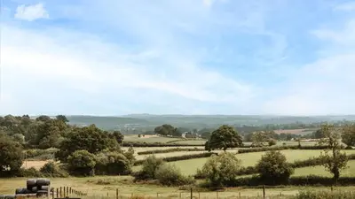 a view of a field with trees and grass at The Piggery in Yarpole