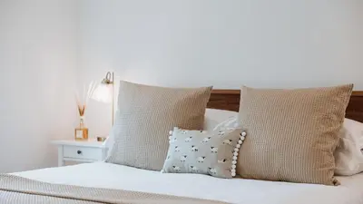 a bedroom with a white bed with pillows at The Piggery in Yarpole