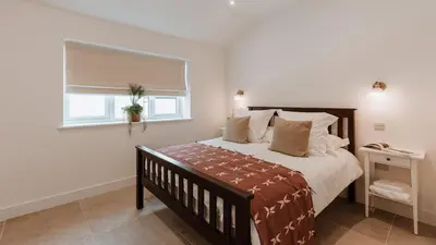 a bedroom with a large bed and a window at The Old Dairy in Yarpole