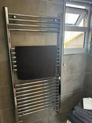 a shower with a glass door in a bathroom at Bay View shepherds hut with hot tub in Llanfair