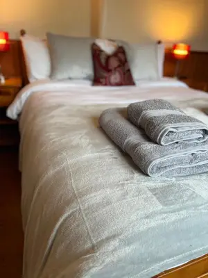 two towels sitting on top of a bed at Frog Cottage, Ludlow - a charming townhouse for 4 in Ludlow
