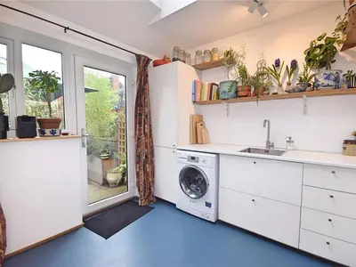 a kitchen with a washing machine and a window at Georgian Terrace Town House in Mid Wales in Newtown