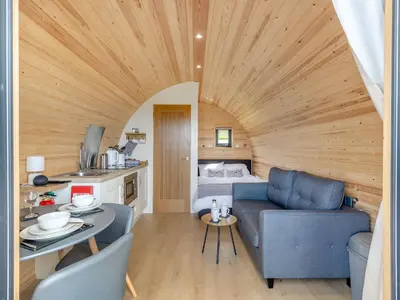 a living room with a couch and a table at Dyfi - Uk46064 in Llancynfelyn