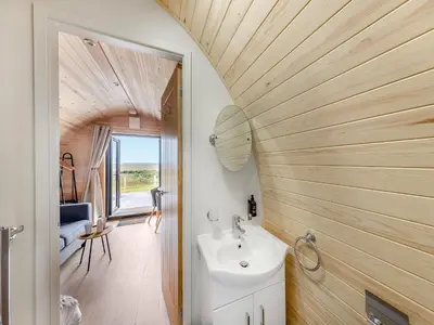 a bathroom with a sink and a mirror at Dyfi - Uk46064 in Llancynfelyn