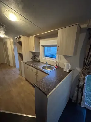a kitchen with a sink and a counter top at Caravan in Barmouth in Llanddwywe