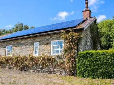 a house with solar panels on the roof at The Mytton at Mill Barn in Craven Arms