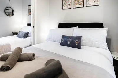 a bedroom with two beds with stuffed animals on the bed at The Little Cygnet in Shrewsbury