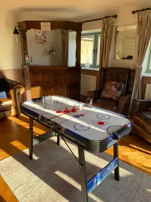 a ping pong table in a living room at Private Lodge with Spa and Sauna in Shrewsbury