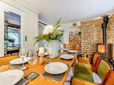 a dining room with a table and a fireplace at Private Lodge with Spa and Sauna in Shrewsbury