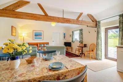 a dining room and living room with a table and chairs at 1 Bed in Hay-on-Wye oc-c29788 in Hay-on-Wye