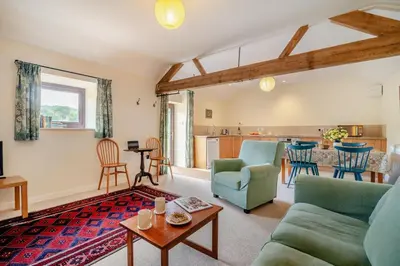 a living room with a couch and a table at 1 Bed in Hay-on-Wye oc-c29788 in Hay-on-Wye