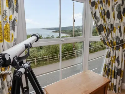 a window with a view of the ocean at Morva in New Quay
