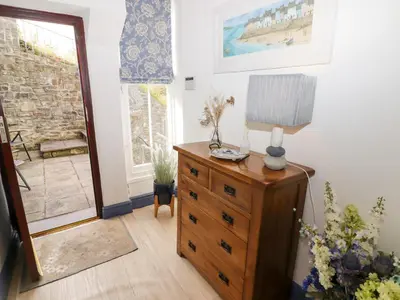 a room with a dresser with a lamp on it at Morva in New Quay