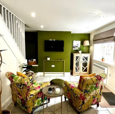 a living room with a couch and a table at Flower Cottage by Ludlow Castle with Onsite Parking in Ludlow