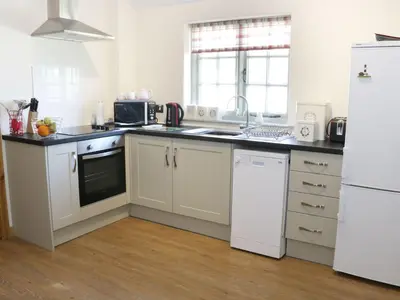 a kitchen with white appliances and a white refrigerator at Ramblers in Newtown