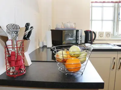 a kitchen with a basket of fruit on a counter at Ramblers in Newtown