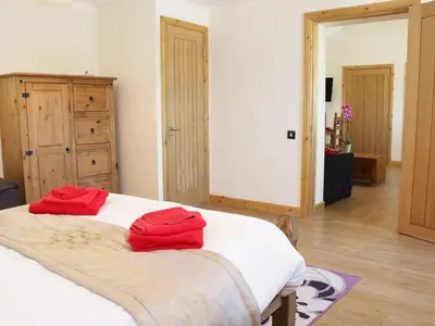 a bedroom with a bed with two red towels on it at Ramblers in Newtown