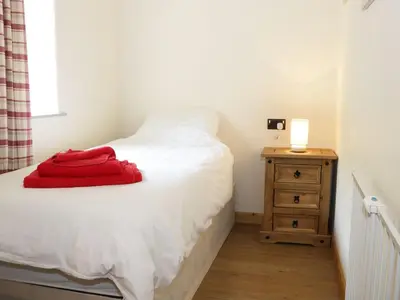 a bedroom with a bed with a red towel on it at Ramblers in Newtown