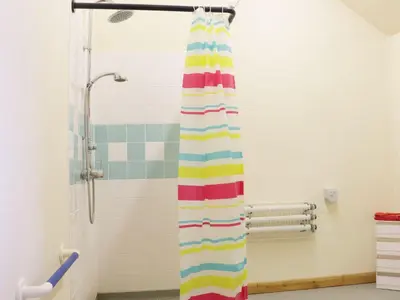 a shower with a colorful shower curtain in a bathroom at Ramblers in Newtown