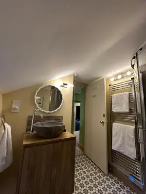 a bathroom with a sink and a mirror at Maengwynedd, Llanrhaeadr Ym Mochnant in Oswestry