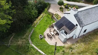 an overhead view of a white house with a solar roof at Maengwynedd, Llanrhaeadr Ym Mochnant in Oswestry