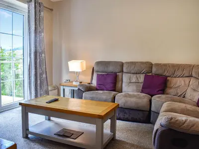a living room with a couch and a table at Haul Y Bore in Aberystwyth
