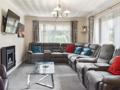 a living room with a couch and a table at Tan Y Gaer in Aberystwyth