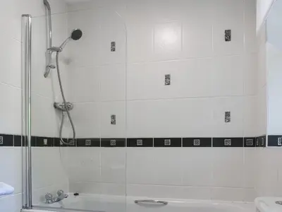 a bathroom with a shower and a sink and a tub at Tan Y Gaer in Aberystwyth
