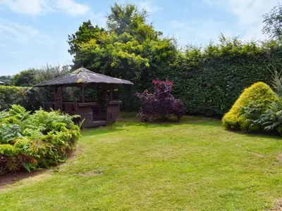 a gazebo in the middle of a garden at Tan Y Gaer in Aberystwyth
