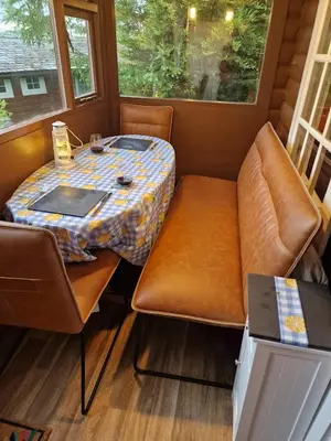 a small table and chairs in a tiny house at Bryn Cnocell in Trawsfynydd