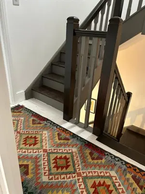 a stairway with a rug on the floor and a staircase with a mosaic floor at The Hat Works in Ludlow
