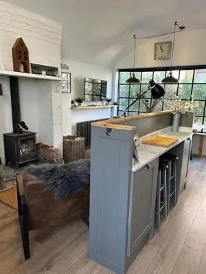 a kitchen with a stove and a couch in a room at The Hat Works in Ludlow