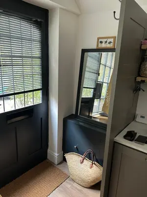 a kitchen with a black door and a mirror at The Hat Works in Ludlow