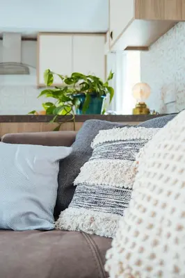a couch with pillows on it in a living room at Foxglove Lodge in New Quay