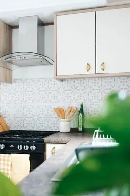 a kitchen with a stove and a counter top at Foxglove Lodge in New Quay
