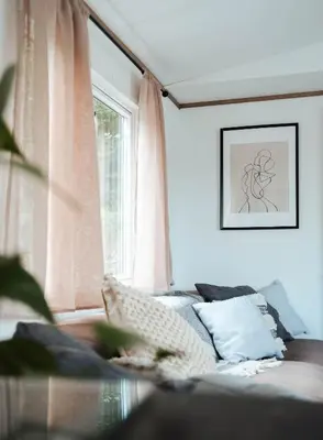 a living room with a couch and a window at Foxglove Lodge in New Quay