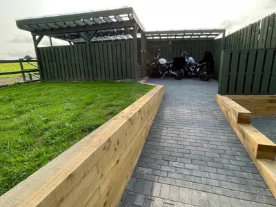a patio with a fence and a grass field at Little Cottage of the Beacons in Brecon