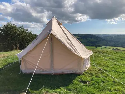 a canvas tent in a field of grass at Fair View Bell Tent in Oswestry